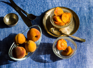 Top view and close-up of peach fruit and peach slices served in glass bowls decorated on a silver plate for the festive look on Diwali.