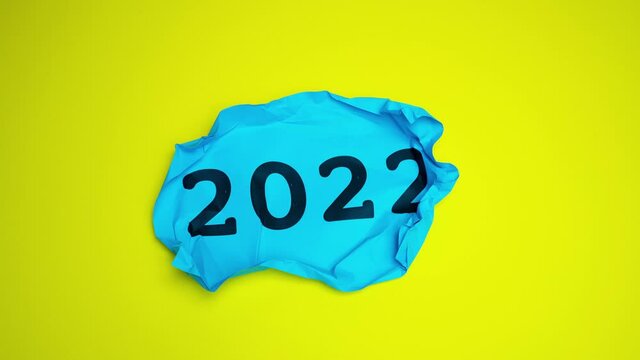 new year's night 2022. A sheet of paper with the year 2021 written on it which is torn up and reopens with the year 2022 written on it