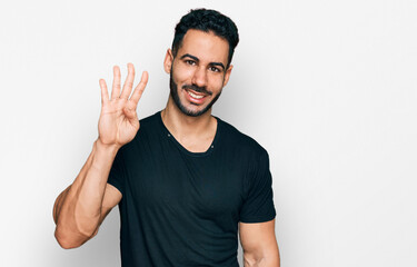 Fototapeta premium Hispanic man with beard wearing casual black t shirt showing and pointing up with fingers number four while smiling confident and happy.