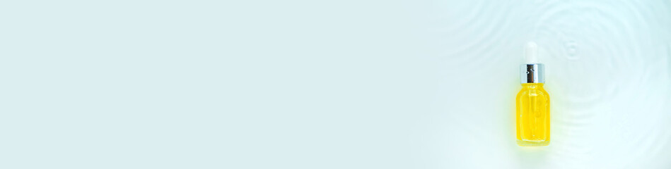 Cosmetics in a bottle in water, skin hydration concept. Hyaluronic acid. Selective focus.