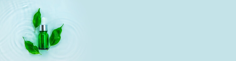 Cosmetics in a bottle in water, skin hydration concept. Selective focus.