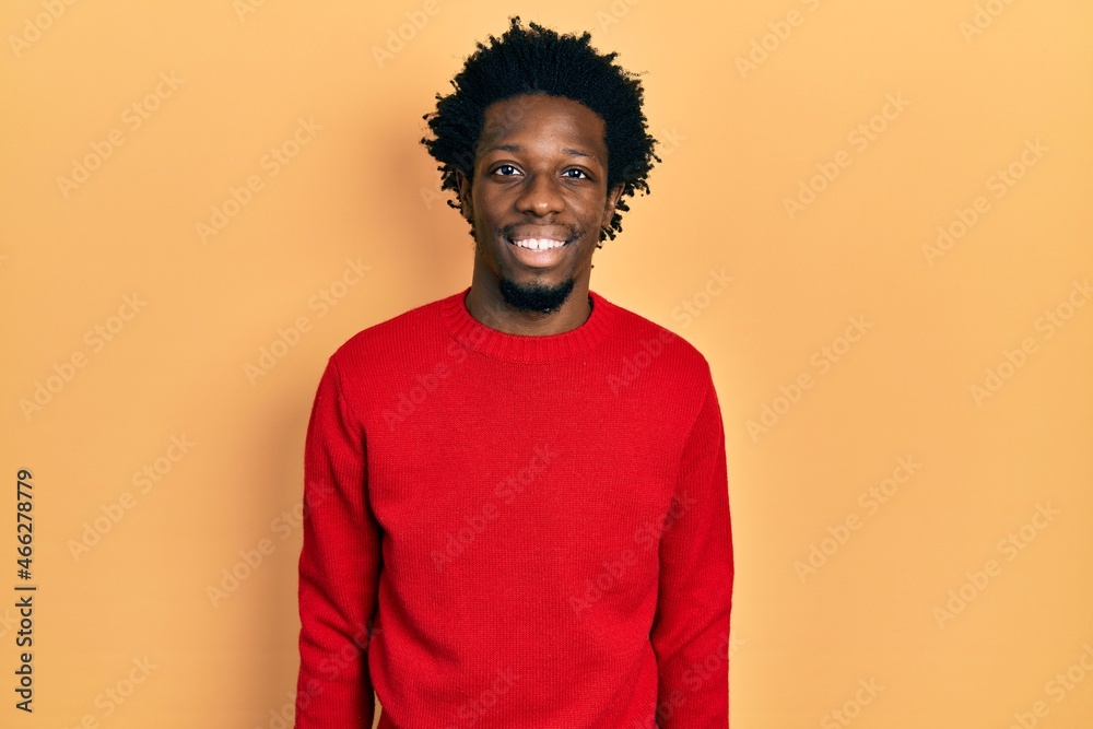 Wall mural Young african american man wearing casual clothes with a happy and cool smile on face. lucky person.