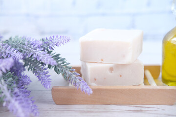 Homemade natural soap bar and dry flower on black background 
