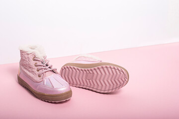 Pink shoes for a girl on a white-pink background.