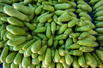 A bunch of zucchini on the bazaar counter.