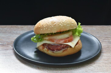 fried mashed beef cheese hamburger and lettuce stuffed mayonnaise sauce with ketchup on plate
