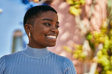 Young african american woman smiling happy standing at the city.