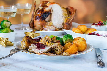 Traditional Christmas dinner with roasted turkey, apricot and pistachio stuffing, roast potatoes and cranberry sauce