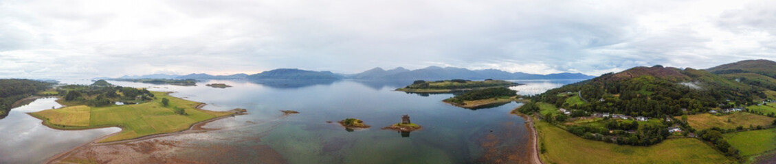Aerial panoramic view of Castle Stalker and Loch Linnhe near Portnacroish, Scotland