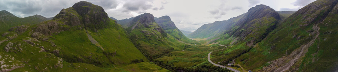 Aerial panoramic view of the waterfalls on the River Coe near Allt-na-ruigh with the Three Sisters in the background, Scotland