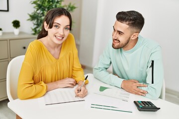 Obraz premium Young couple controlling family economy at home.