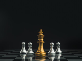 Golden queen chess piece standing in the center of little silver pawn pieces on chessboard on dark...