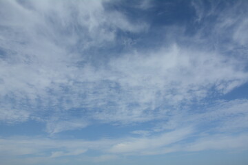 Obraz premium Unusual cirrus clouds in the blue sky. Beautiful sky background.
