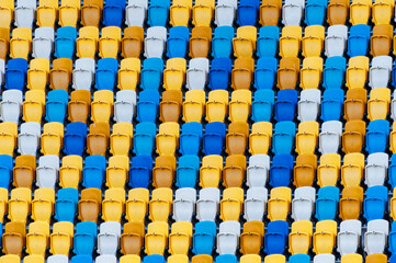 Fototapeta premium Closeup of yellow and blue seats on stadium