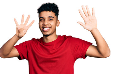 Young african american man wearing casual red t shirt showing and pointing up with fingers number...