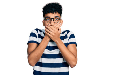 Young african american man wearing casual clothes and glasses shocked covering mouth with hands for...