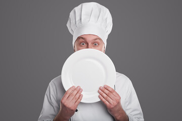 Chef with white plate looking at camera