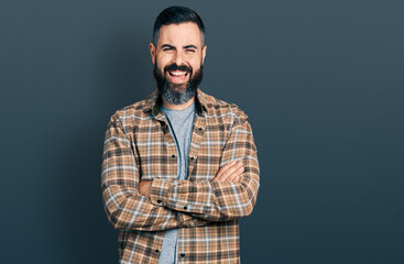 Hispanic man with beard with arms crossed gesture smiling and laughing hard out loud because funny crazy joke.