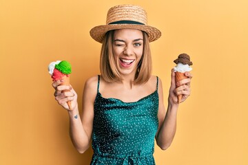 Young caucasian blonde woman eating ice cream cone winking looking at the camera with sexy...