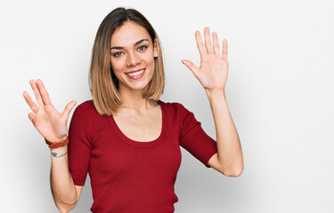 Young blonde girl wearing casual clothes showing and pointing up with fingers number nine while...
