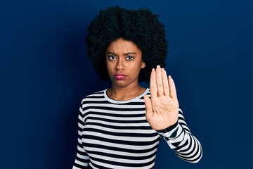 Young african american woman wearing casual clothes doing stop sing with palm of the hand. warning expression with negative and serious gesture on the face.