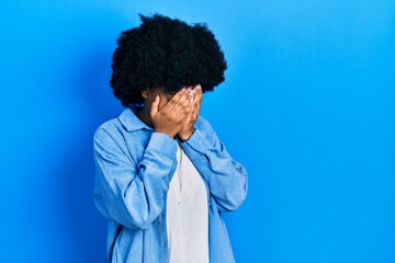 Fototapeta na wymiar Young african american woman wearing casual clothes with sad expression covering face with hands while crying. depression concept.