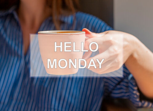 Hello monday concept. Words on coffee cup in women hand.