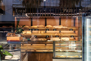 Bakery showcase with assorted baked goods, breads and loaves.