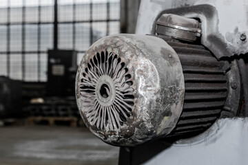 Old flange motor of milling machine industrial equipment in the factory workshop