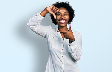 African american woman with afro hair wearing casual white t shirt smiling making frame with hands and fingers with happy face. creativity and photography concept.