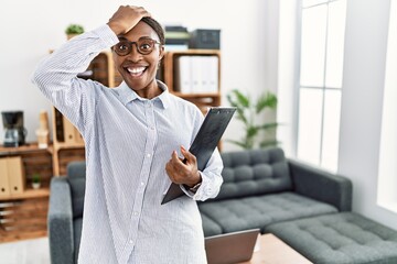 African woman working at psychology clinic surprised with hand on head for mistake, remember error....