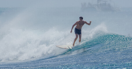 Surfer surfing on a longboard