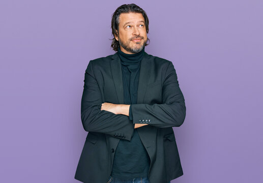 Middle age handsome man wearing business clothes smiling looking to the side and staring away thinking.