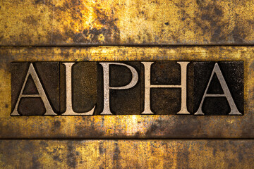 Alpha text message on textured grunge copper and vintage gold background