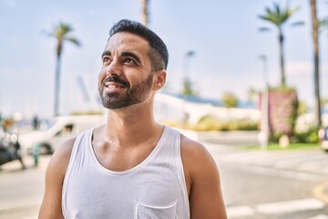 Hispanic sports man wearing workout style outdoors on a sunny day
