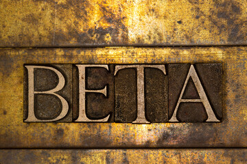 Beta text message on textured grunge copper and vintage gold background