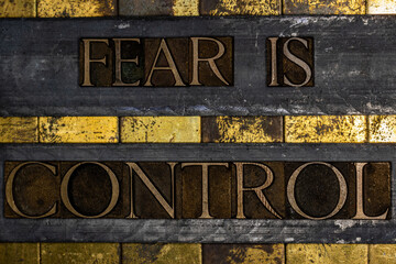 Fear Is Control text on textured grunge copper and vintage gold background