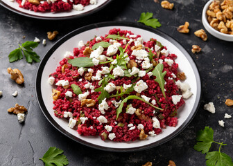 Bulgur salad with beetroot, walnuts, arugula and feta cheese. Healthy diet food