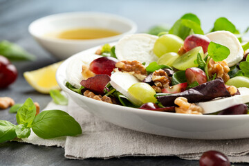 Italian salad with goat cheese, grapes and walnuts. Healthy Food
