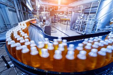 Conveyor belt with bottles for juice or water at a modern beverage plant