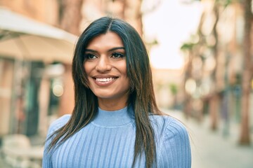 Beautiful hispanic woman smiling confient at the city