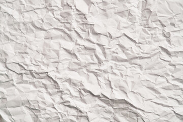White crumpled paper texture with wrinkles. Damaged and torn sheet