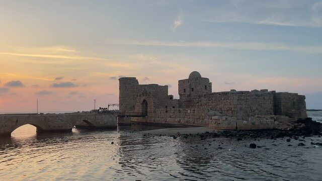 The city of Sidon in Lebanon. Sidon Sea Castle, built by the crusaders - Saida corniche and building. Sidon sea at sunset