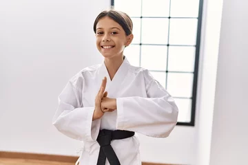 Fotobehang Young hispanic girl doing martial arts at training studio © Krakenimages.com