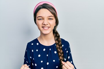 Young brunette girl wearing elegant look very happy and excited doing winner gesture with arms raised, smiling and screaming for success. celebration concept.