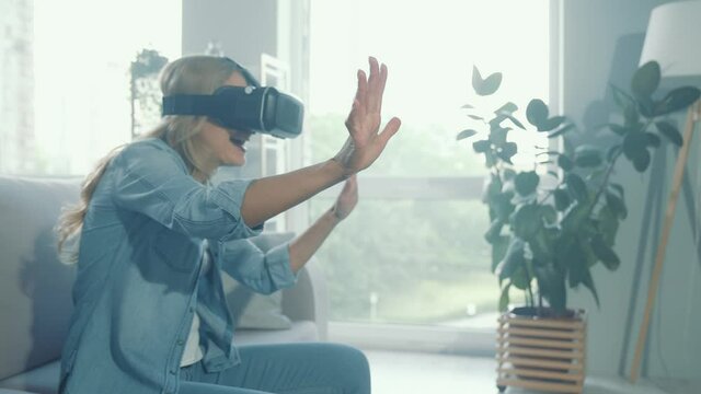 Funny blonde lady have fun vr goggles video game free time