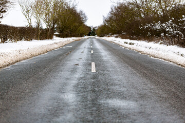 A freshly cleaned and gritted road that has been cleared by the council to ensure safe travel during dangerous conditions in the winter