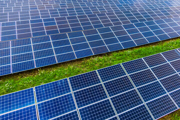 Top view of blue shiny solar photo voltaic panels system producing renewable clean energy abstract background.