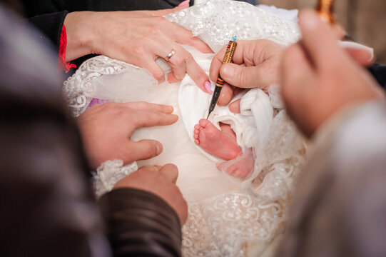 sacrament of baptism the priest baptizes the child with the anointing