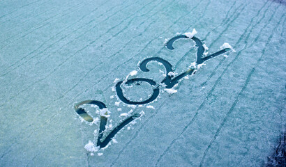 2022 is written on the windshield of the car,on morning frost New Year. Winter concept